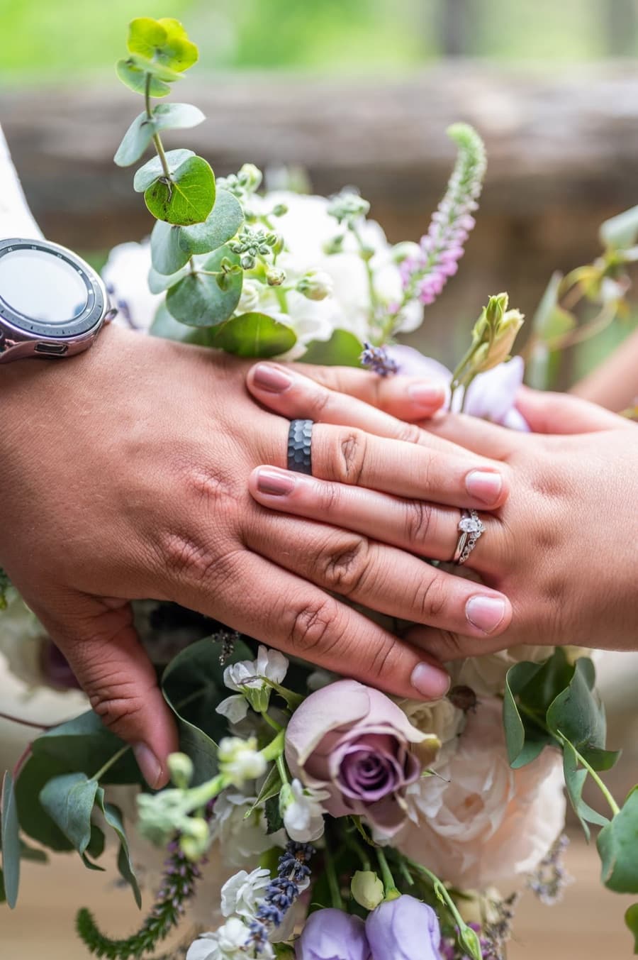 Wedding rings resting on a bouquet